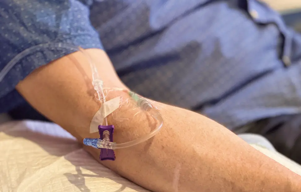A close up a person's arm with an IV.