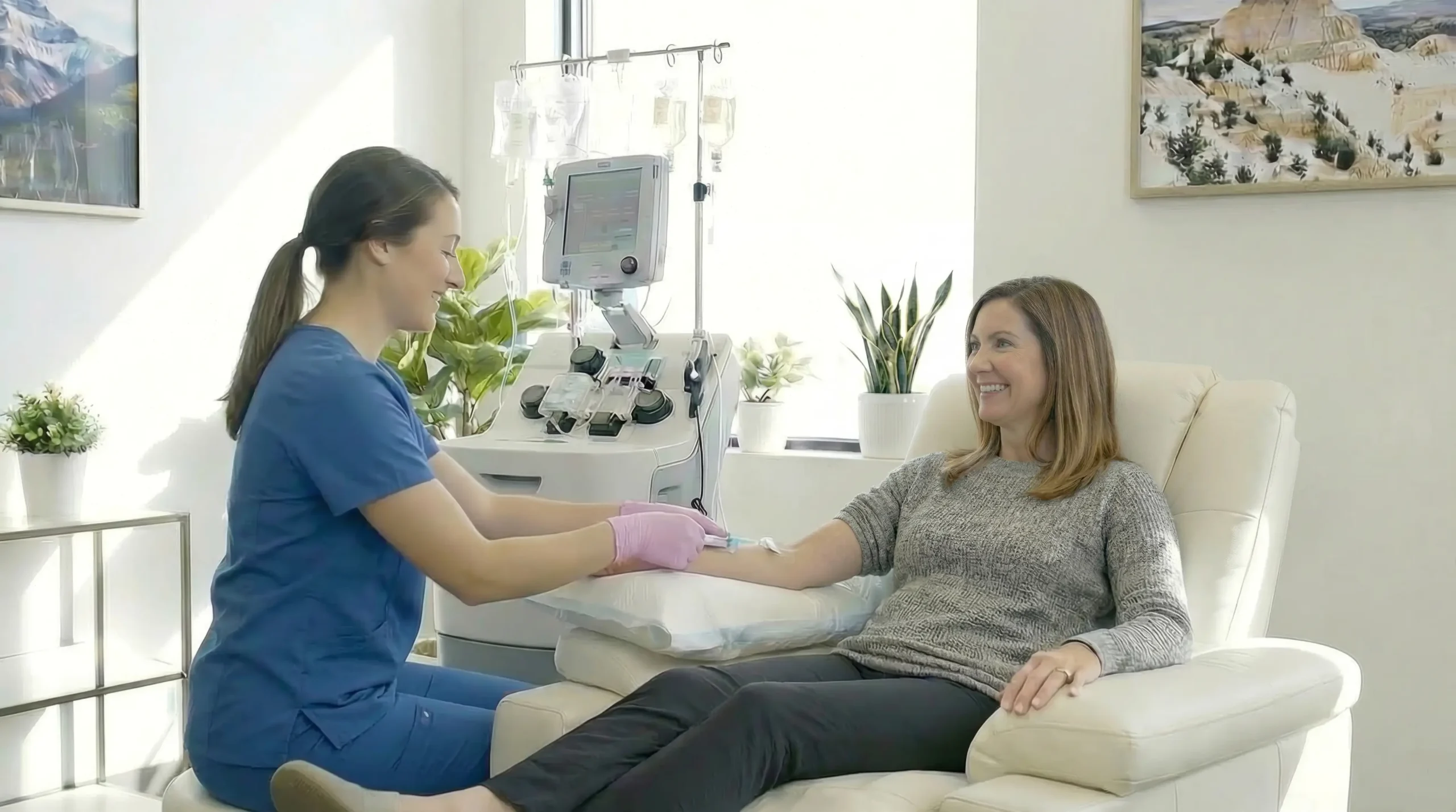 Woman in hospital room with healthcare professional.